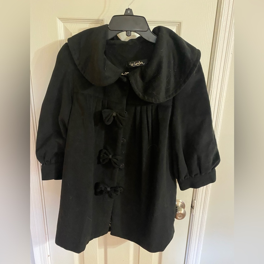 Black LuLuvia Jacket with Bow buttons. Quarter length sleeves